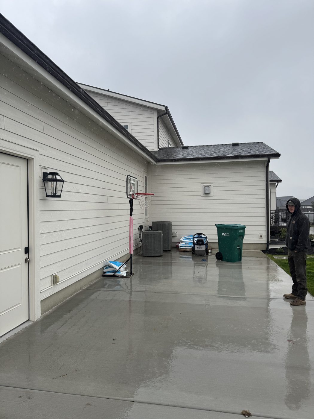 Before: empty concrete pad beside the garage