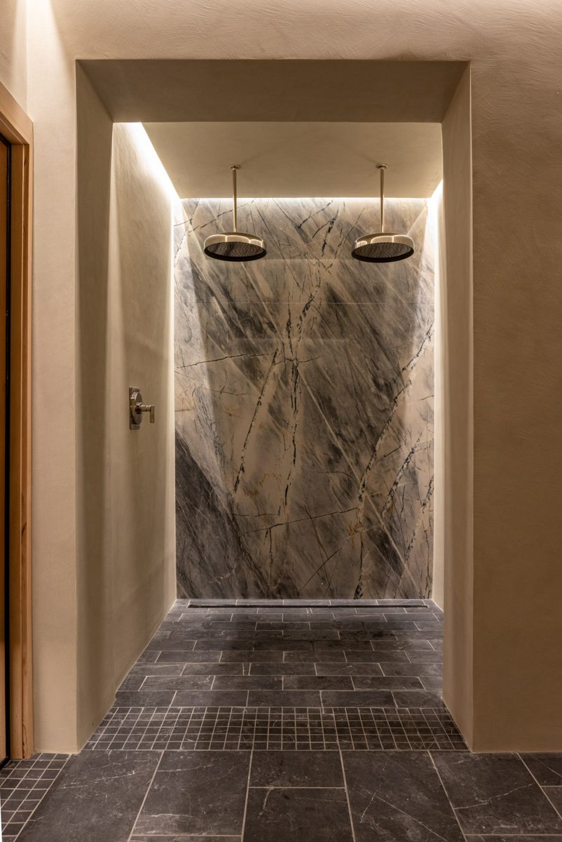 Marble slab shower with dual rain heads
